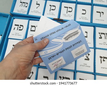HOLON, ISRAEL. March 23, 2021. Hand holding elections ballot envelope at the polling station prior to the voting at the Knesset elections in Israel. Israel parliamentary elections 2021.