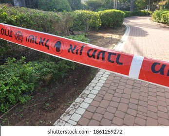 HOLON,, ISRAEL. November 25, 2020. Red Police No Trespassing Tape That Says In Hebrew: Police Line, Don't Cross. Israel Crime Concept Image, Murder Site, Terror Attack 