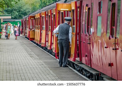 Holt, Norfolk, UK – September 14 2019. Train Conductor Dressed In 1940's Style Clothing Checking In Passengers Aboard A Vintage Rail Carriage During The Annual Forties Weekend