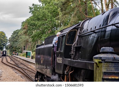 Holt, Norfolk, UK – September 14 2019. Train Driver Parking Up Black Steam Train On The Poppy Railway Line In Holt Norfolk