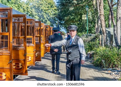 Holt, Norfolk, UK – September 14 2019. Train Conductor On Platform 2 Of Holt Train Station On The Poppy Line Indicating An Empty Carriage During The Annual Forties Weekend