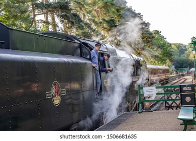 Holt, Norfolk, UK – September 14 2019. Train Driver And Mate Looking Out From The Black Prince Steam Train At Holt Railway Station