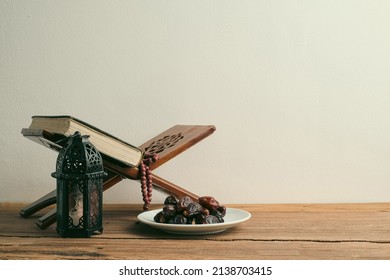 The Holy Al Quran with written Arabic calligraphy meaning of Al Quran and rosary beads or tasbih, Arabic word translation : The Holy Al Quran - Shutterstock ID 2138703415