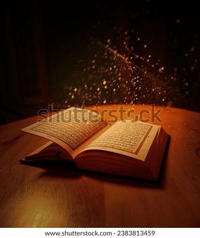 Holy Al Quran with written Arabic calligraphy meaning of Al Quran on black background. Copy space and crop fragment, Opened Quran