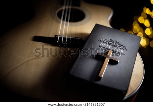 Holy Bible with acoustic guitar and\
religious crucifix cross, gospel music\
concept