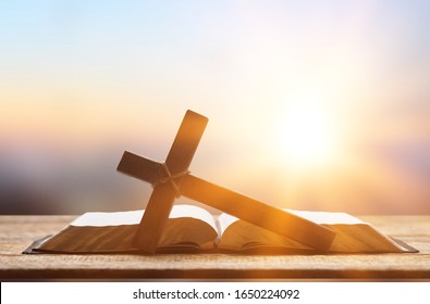 Holy Bible book and cross on a wooden desk