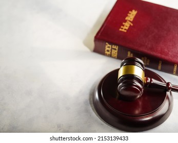 Holy bible book and judge's gavel on white background. Judicial system, constitution, democracy, rule of law. There are no people in the photo. There is free space to insert.