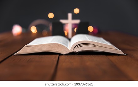  Holy Bible with cross on the bokeh background