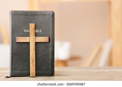 Holy Bible With Cross On Table In Room