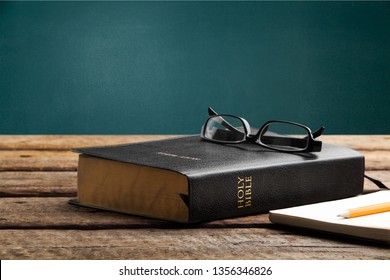 Holy Bible With Eye Glasses And Note