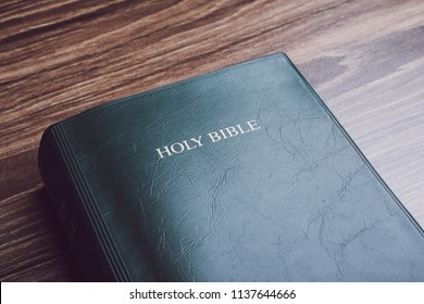 Holy Bible On The Wooden Desk.