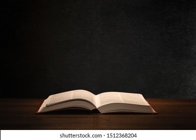 Holy Bible in a school teacher desk with a blackboard in the background. - Shutterstock ID 1512368204