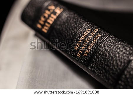 Holy Bible scripture book with version name on the spine, gold title revised standard version