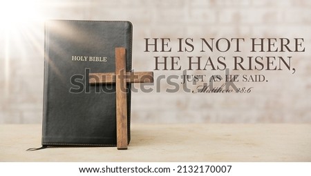 Holy Bible with wooden cross on light background