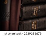 Holy Bibles in a library, vintage copies in genuine leather covers.