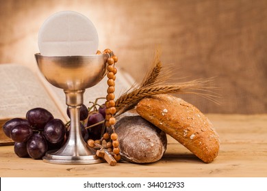 holy communion chalice on wooden table - Shutterstock ID 344012933