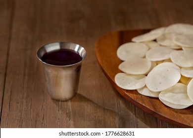 Holy communion on wooden table on church. Cup with red wine, bread. Taking holy Communion. The Feast of Corpus Christi Concept. - Shutterstock ID 1776628631