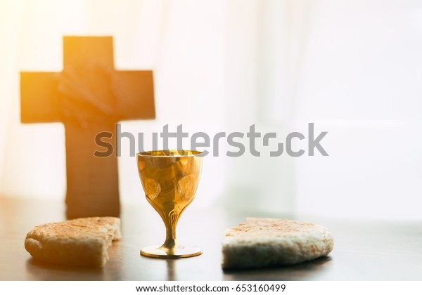 holy communion on wooden table on\
church.Taking Communion.Cup of glass with red wine, bread and Holy\
Bible and Cross on wooden table.black and\
white.
