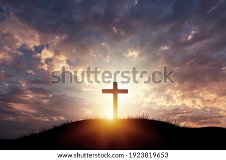 Holy concept: Silhouette wooden cross on  mountain sunset background