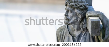 Holy cross with crucified Jesus Christ. Ancient statue. Copy space.