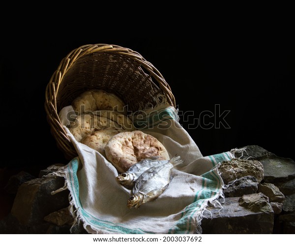 Holy fresh raw simple rural box barley pita cake\
bakery Lord pray bless retro Israel sign story. Close up view white\
jew towel cloth catch catholic supper still life dark black stone\
field text space