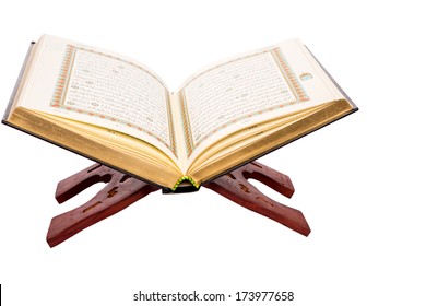 The holy Quran on a wooden book stand over white background - Shutterstock ID 173977658