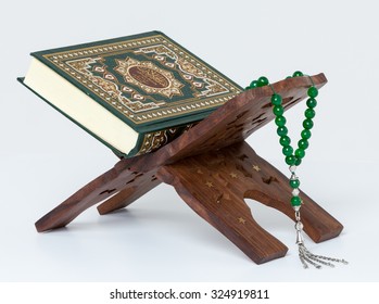 Holy Quran and prayer beads on stand