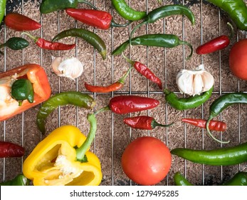 Holy Trinity - A Collection Of Capcicum Tomato And Chilli Peppers In The Smoker Before Making Hot Sauce