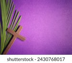 Holy Week, Lent, Palm Sunday, Good Friday, Easter Sunday Concept. Cross shaped and palm leaf in purple background with copy space.