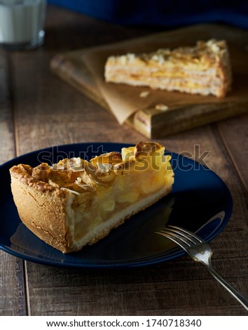 Home apple pie on dark blue plate. Roustic scene, food photography. Wooden surface       