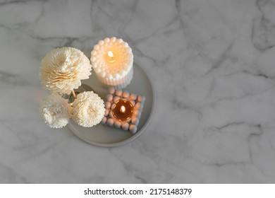 Home Aroma Fragrance Diffuser And Burning Candles On Marble Background. Interior Elements. Home Aroma. Wellness. Top View
