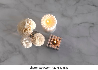 Home Aroma Fragrance Diffuser And Burning Candles On Marble Background. Interior Elements. Home Aroma. Wellness. Top View