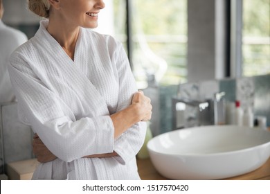 Home atmosphere. Kind woman crossing arms on chest while enjoying her calm morning