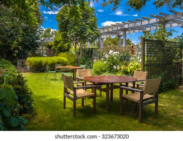 Home Backyard With Garden Table Set In Sunny A Lush Garden With Shade Of Trees