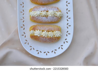 Home Baked Bread Cakes With Cheese. Cheesecakes With Pumpkin Buns Sliced And Stuffed With Creamy Cheese And Sprinkled With Sugar Powder. Sweet Sandwich Breads. Bread Rolls With Soft Yellow Crumb.