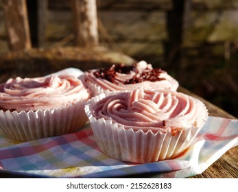 Home Baked Cupcake Decorated With Pink Frosting In The Garden Close Up Shot Selective Focus