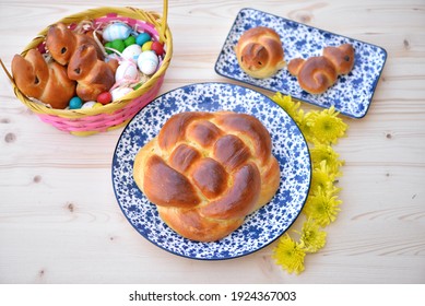 Home baked festive sweet breads: Challah braided bread, brioche Easter chickens and bread bunnies with Easter eggs in wooden basket