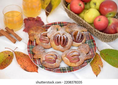 Home Baked Fruit Buns, Sweet Bread Buns In A Shape Of Apple With Sliced Apple, Sprinkled With Sugar And Cinnamon. Plate With Fresh Baked Apple Bread Cakes, Glass Of Juice And Apples In Background.