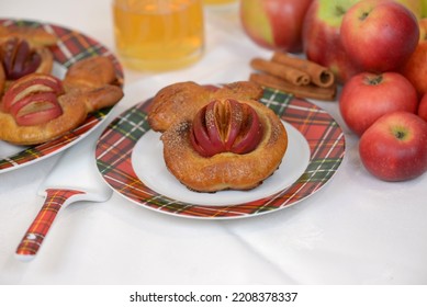 Home Baked Fruit Buns, Sweet Bread Buns In A Shape Of Apple With Sliced Apple, Sprinkled With Sugar And Cinnamon. Plate With Fresh Baked Apple Bread Cakes, Glass Of Juice And Apples In Background.