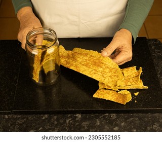 Home baked sourdough crust being broken up into healthy, organic DIY sourdough crackers - Powered by Shutterstock