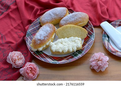 Home Baked Sweet Bread Rolls With Fresh Cheese And Cream On Wooden Table. Sweet Sandwich Breads On Red Plate With Red Tablecloth And Roses. Sliced Small Breads, Milk Buns Stuffed With Creamy Cheese.