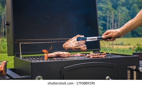 Home Barbecue With Charcoal In The Backyard Grilling Steaks And Other Meats For Carnivore Diet.