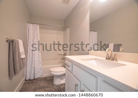 Home bathroom interior with dark gray tile floor and light gray wall