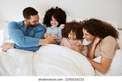 Home bedroom, happy children and parents relax, laugh and bond with kids, rest and enjoy quality time together. Bed, youth and top view of mother, father or family wellness, love and morning care - Powered by Shutterstock