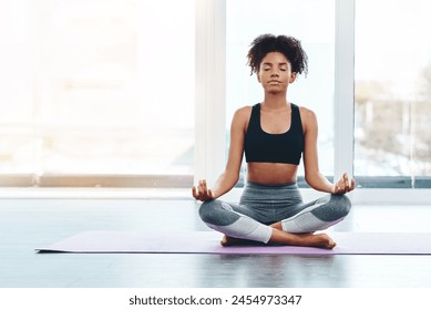 Home, black woman and yoga with lotus pose for peace, meditation and zen healing indoor with lens flare. Health, fitness and female person with mockup space, spiritual balance and freedom at gym - Powered by Shutterstock