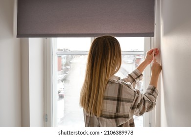 Home blinds or window curtains girl opens the window in the morning. Morning rituals
 - Shutterstock ID 2106389978