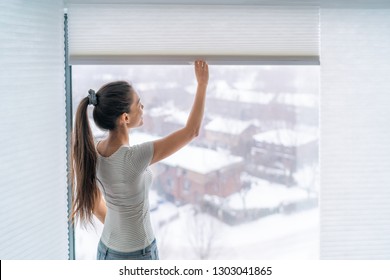 Home Blinds Window Shades Woman Opening Shade Blind During Winter Morning. Asian Girl Holding Modern Cordless Top Down Luxury Curtains Indoors.