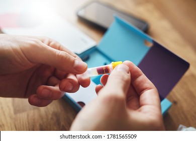 Home Blood DNA COVID-19 Test With Man Holding Test Tube Sample.