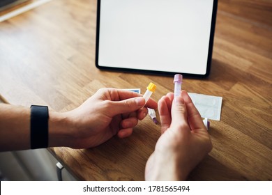 Home Blood Test Kit With Blank Screen On A Digital Tablet In Kitchen.