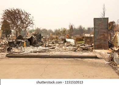 Home Burned To The Ground In The Recent Wild Fire Fire Storm In Redding, California. Smoke And Ash In The Air As The Fire Continues To Burn Several Miles Away.